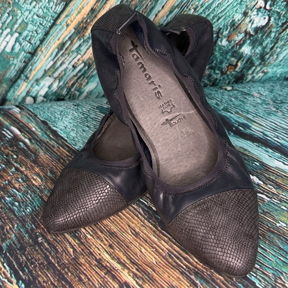 * Tamari’s dark navy leather, flat with snake detail